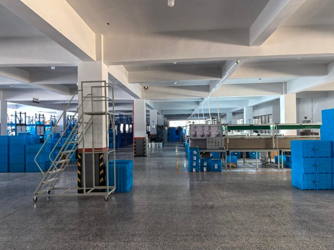Workshop overview with organized work areas and blue storage containers